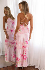Rear view of a pink floral print maxi dress with criss-cross tie-back straps and tiered ruffles
