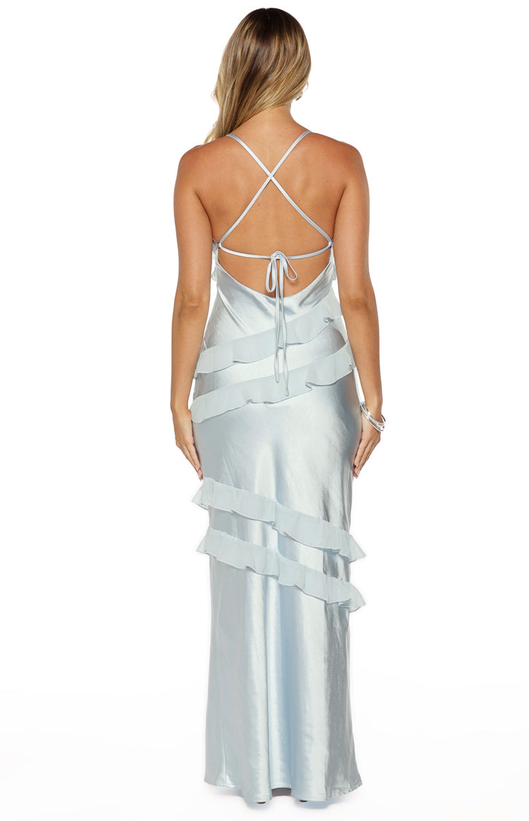 Rear view of a light blue satin maxi dress with criss-cross spaghetti straps, a tie-back, and tiered ruffles