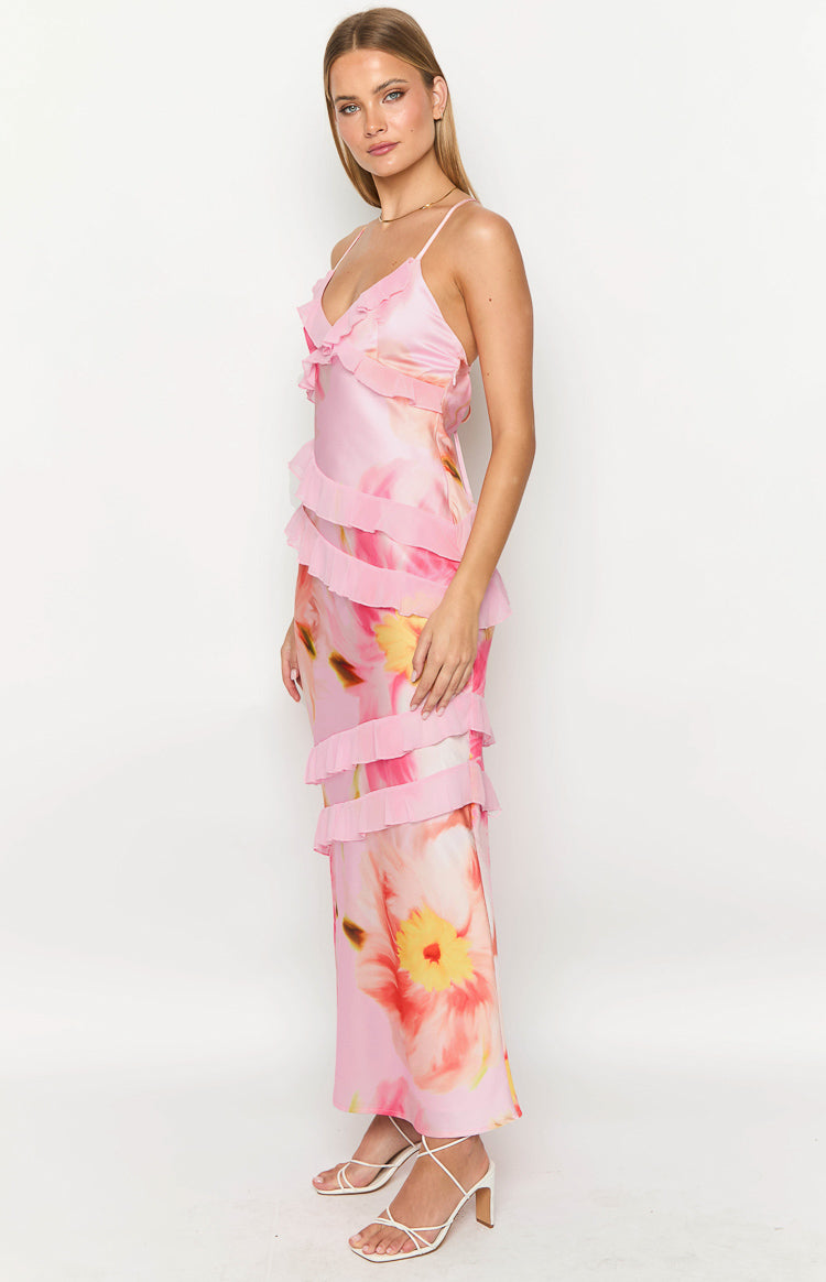Side view of a light pink floral print maxi dress with tiered ruffles down the side