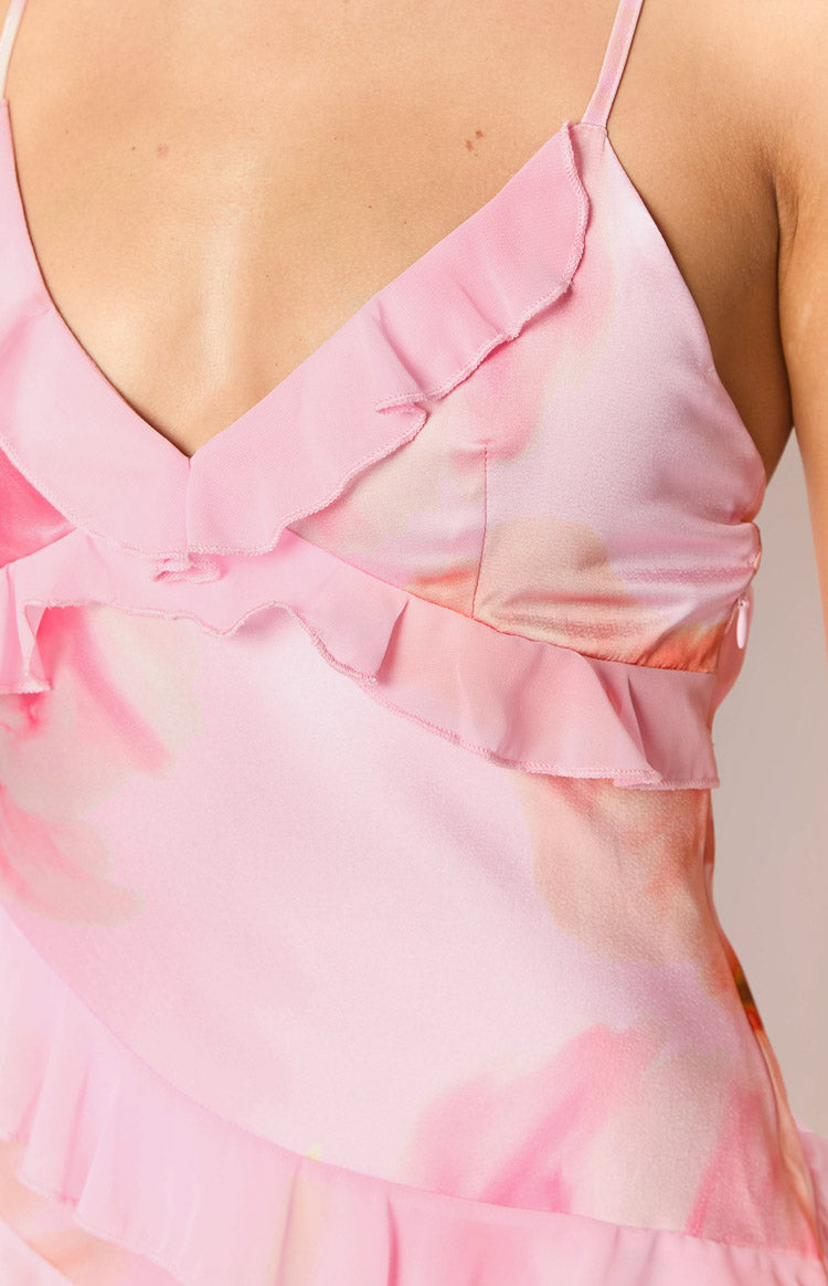 Close-up of the light pink floral print maxi dress bodice showing ruffled V-neckline, spaghetti straps, and side zipper
