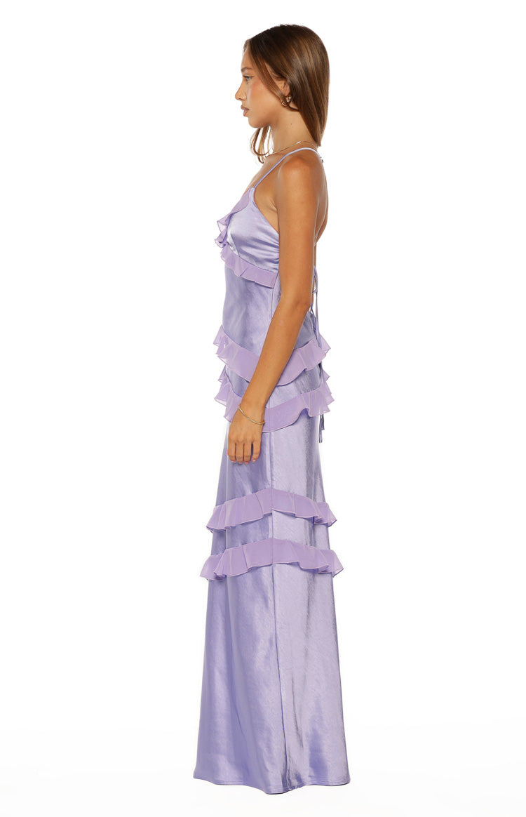 Side view of a lilac satin maxi dress with tiered ruffles and thin spaghetti straps, showing the tie-back detail