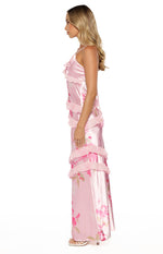 Side view of a pink floral print satin maxi dress with tiered ruffles and spaghetti straps