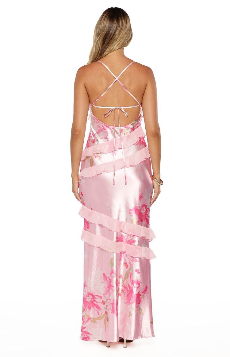 Rear view of a pink floral maxi dress with criss-cross tie-back straps and tiered ruffles