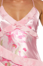 Close-up of the pink satin V-neckline with sheer ruffles and pink floral print on a maxi dress