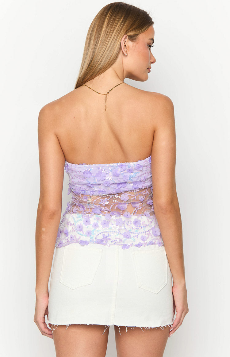 Rear view of a purple sequin strapless top with floral appliques and a sheer mesh lower back
