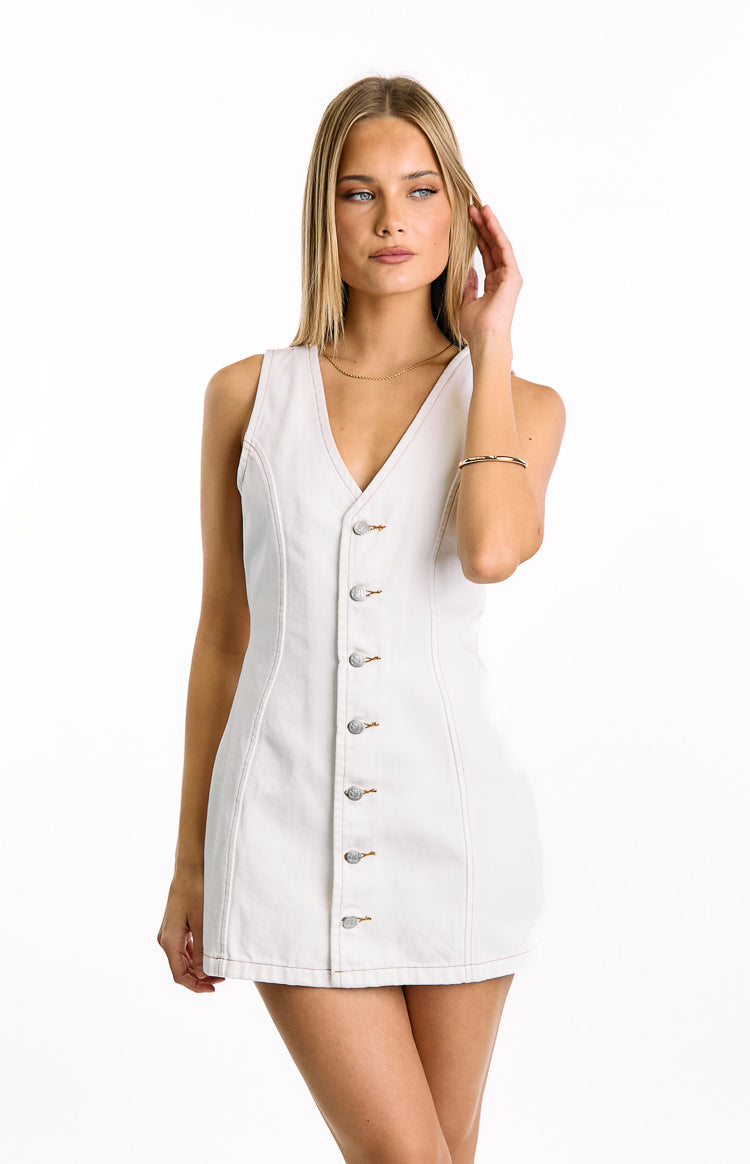 Sleeveless white wash denim mini dress with a V-neckline, button-front, and tan topstitching