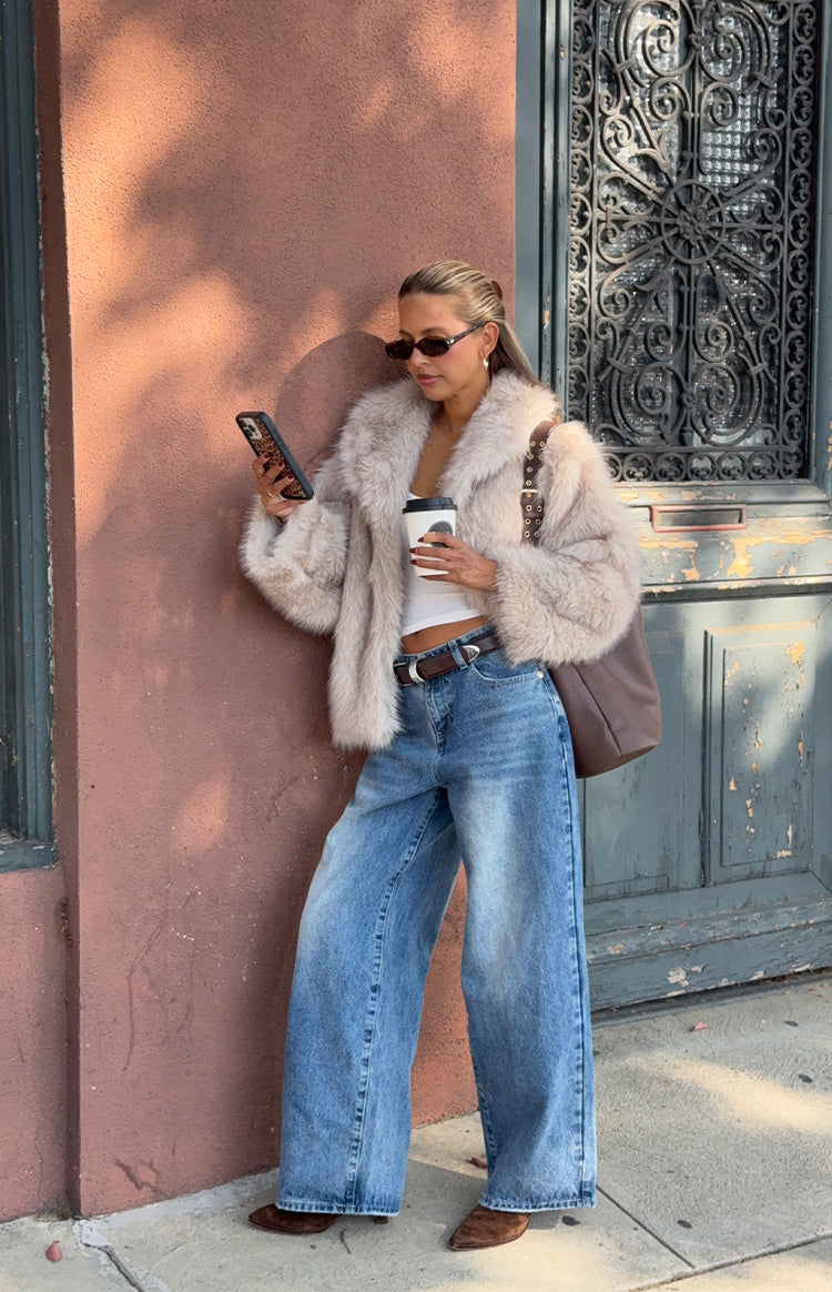 Sand faux fur jacket with wide collar and cropped length, showing fluffy texture