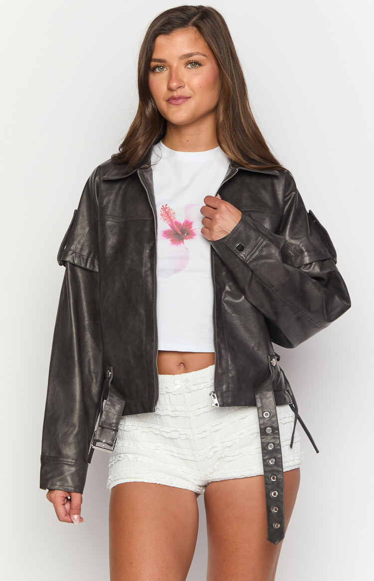 Front view of a washed black PU jacket with a pointed collar, shoulder flaps, and distressed texture