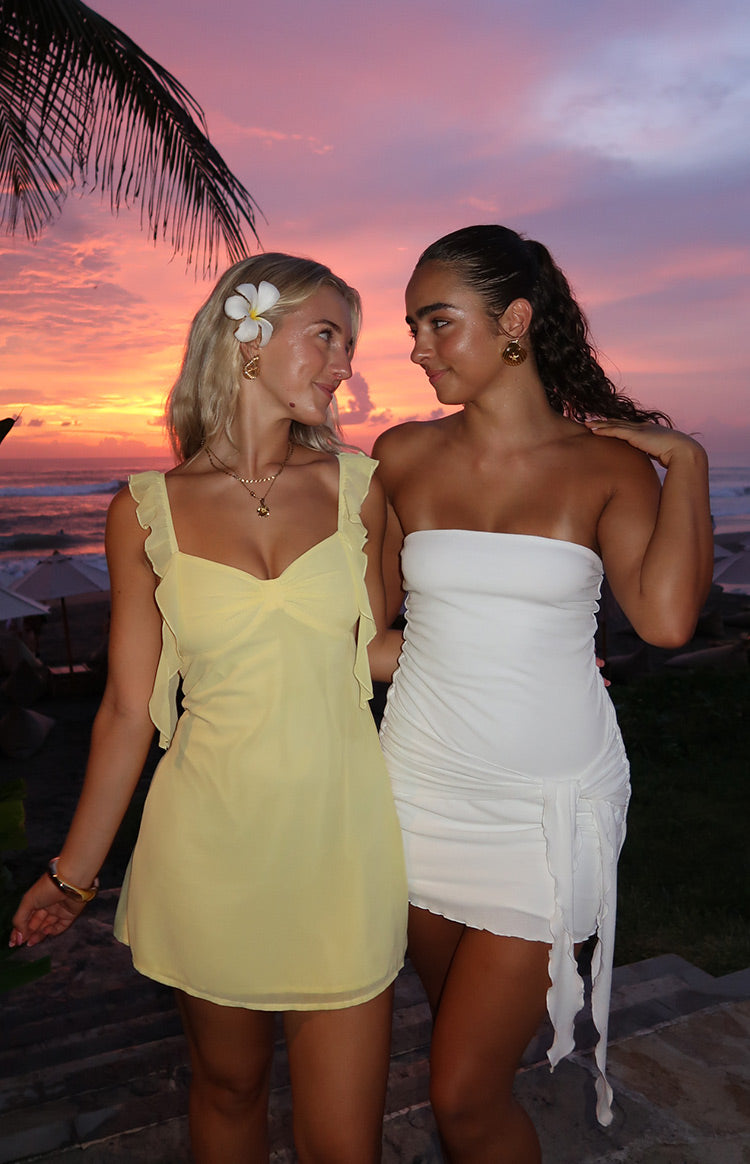 Flowy yellow chiffon mini dress with ruffled straps and tie-front sweetheart neckline evening