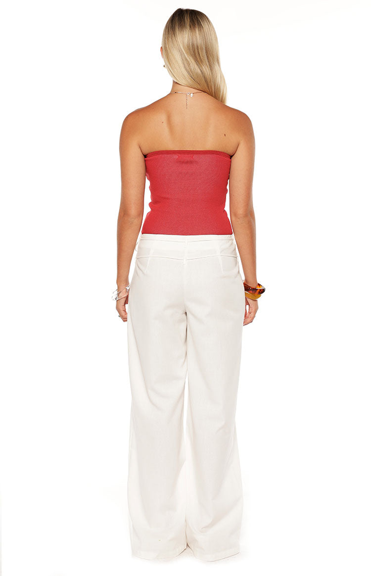 Rear view of white wide-leg pants with subtle back waist stitching and wide flowing legs