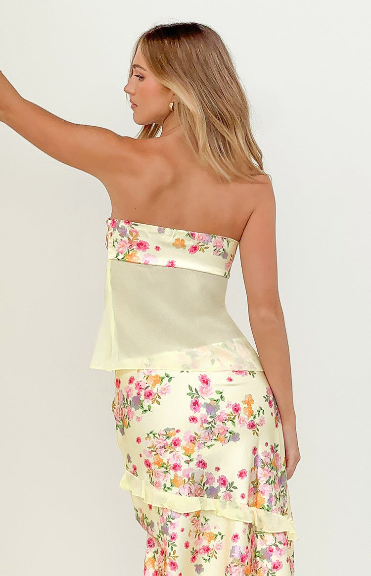 Side view of a yellow strapless top with a floral bust band and sheer torso panel