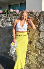 Yellow maxi skirt with a flowy silhouette and high waist, showing the full length