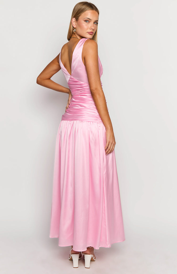 Side view of a pink sleeveless maxi dress with a deep V-back, ruched bodice, and flowing skirt