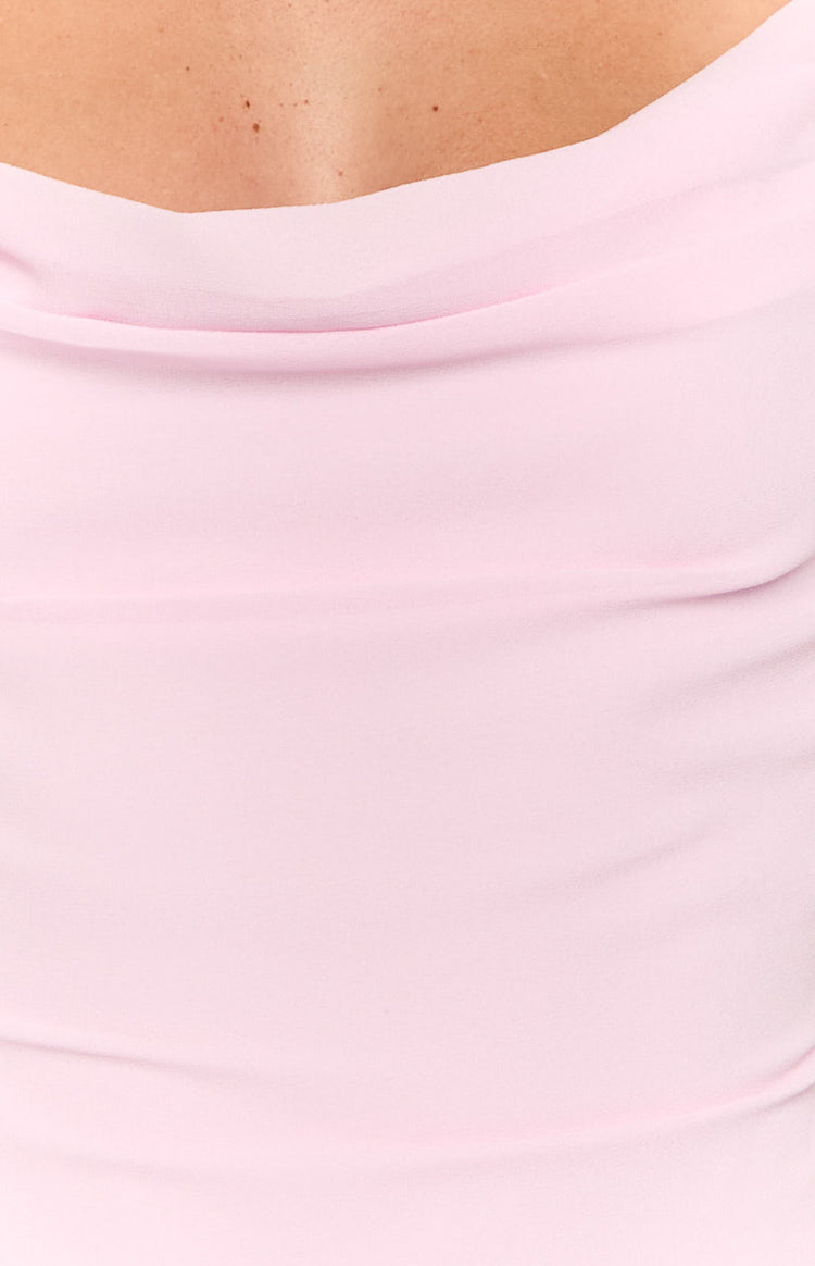 Close-up of the light pink mini dress showing the soft draping of the cowl neckline and fabric texture