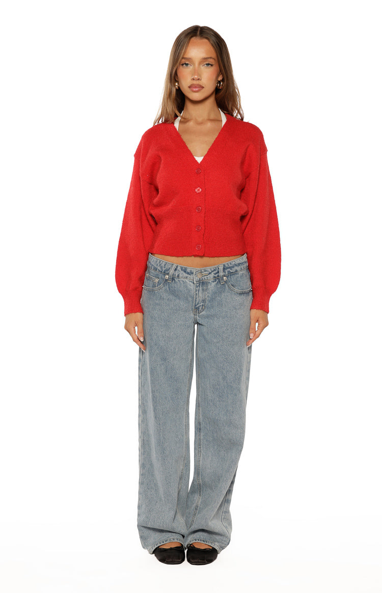 Front view of a red soft knit oversized cardigan with a V-neck, button-front, and long voluminous sleeves