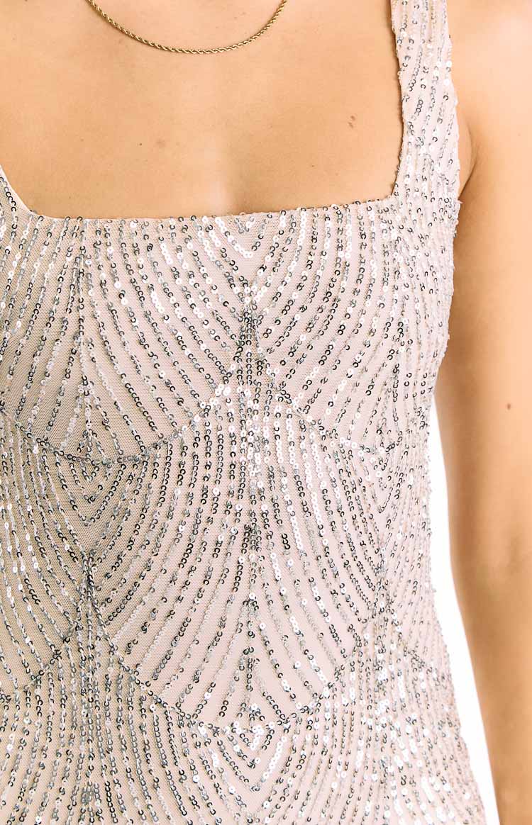 Close-up of the geometric silver sequin pattern on the bodice of a square neck mini dress
