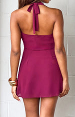Rear view of a burgundy halter neck mini dress, showing the tie closure at the back of the neck