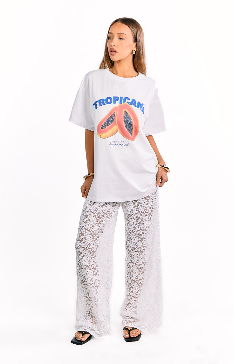 Full length front view of white floral lace wide-leg pants with a sheer finish