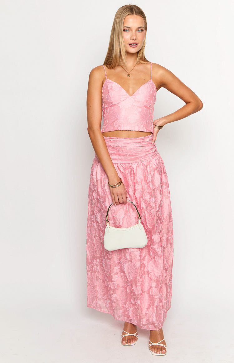 Front view of a jewel pink floral maxi skirt featuring a wide ruched elasticated waistband and textured floral pattern