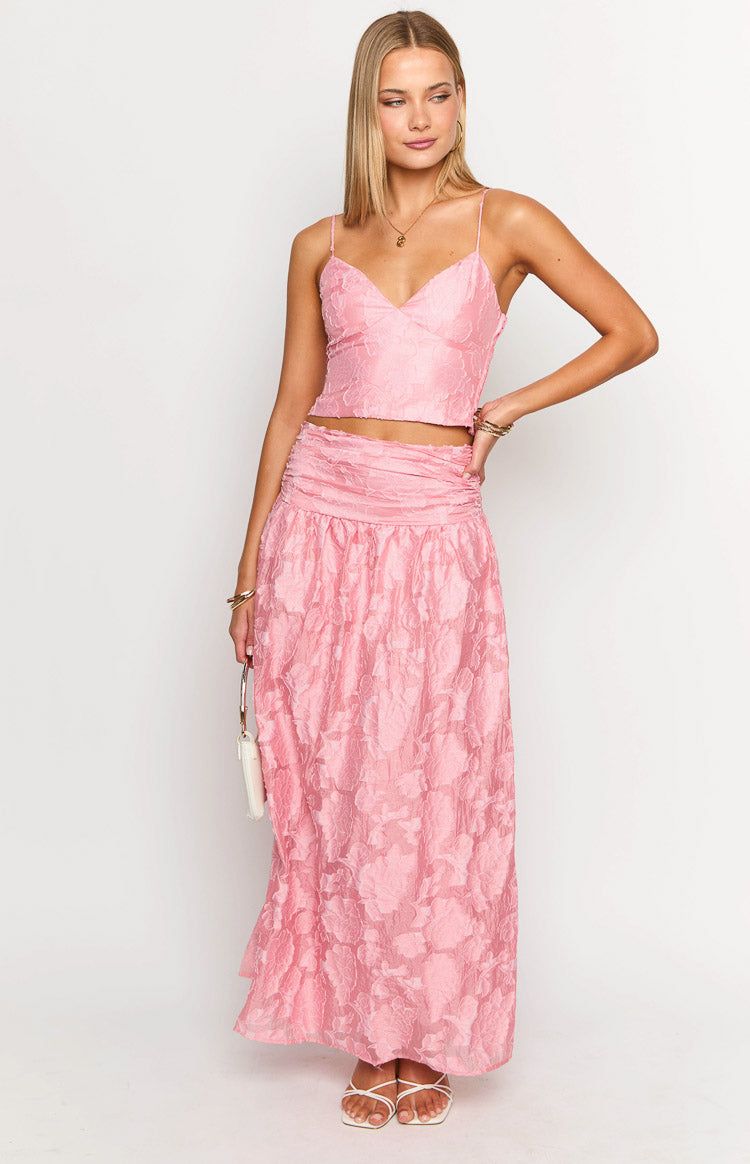Front view of a pink maxi skirt with a ruched high waist and an embossed floral texture throughout