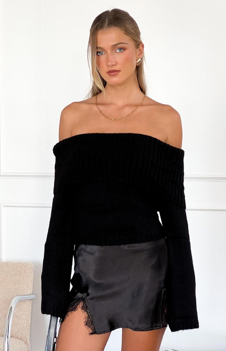 Front view of a black off-shoulder sweater with a wide ribbed fold-over neckline and long sleeves