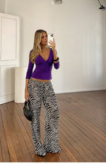 Full length view of black and white sheer zebra print wide-leg pants with a visible drawstring waist
