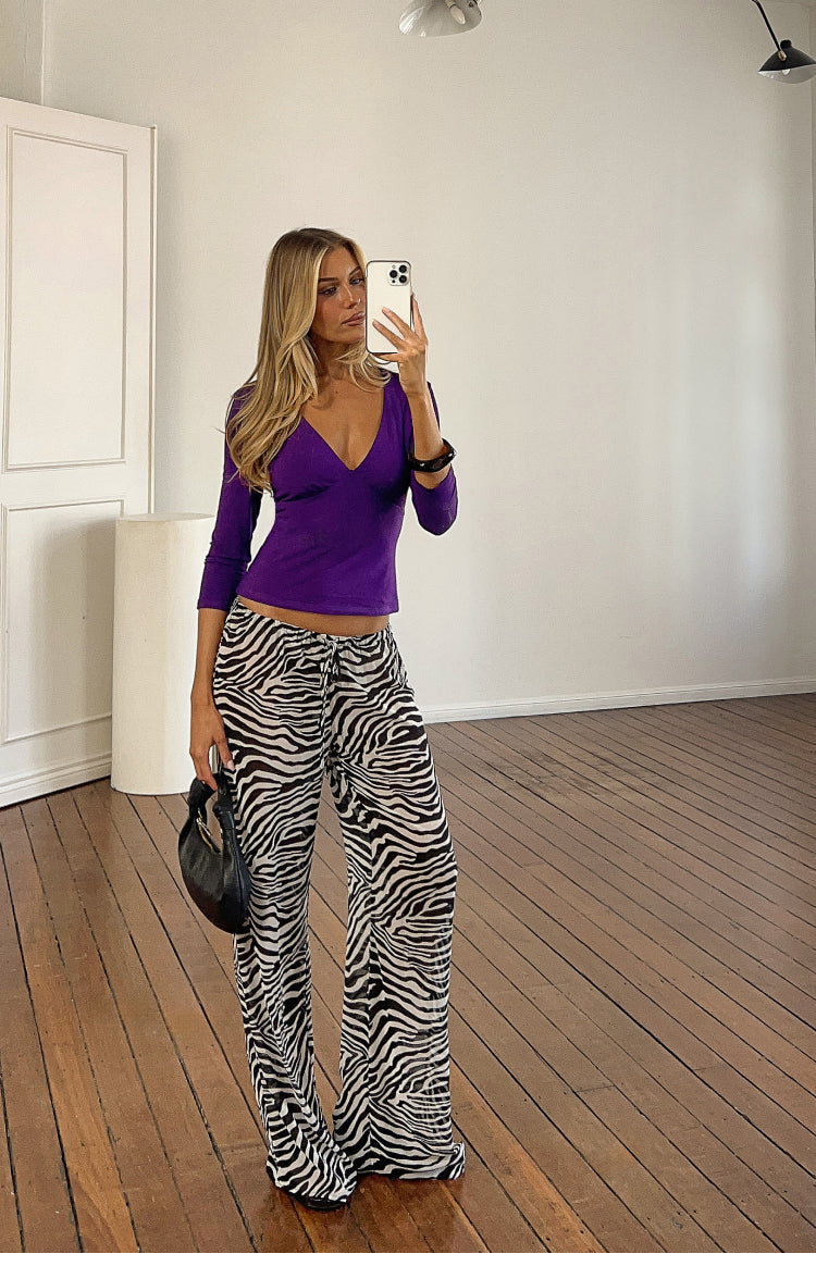 Full length view of black and white sheer zebra print wide-leg pants with a visible drawstring waist