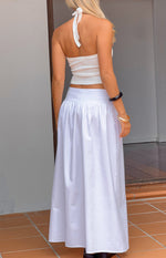 Rear view of a white gathered waist maxi skirt with a flowy silhouette