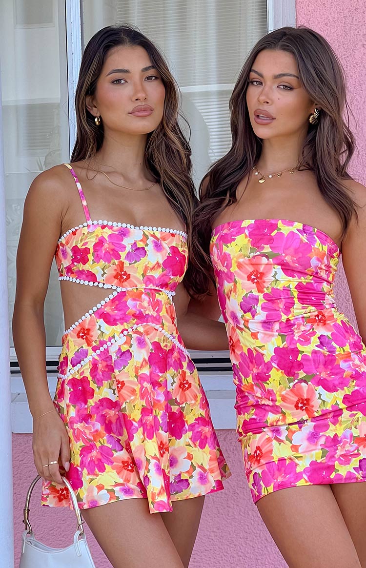 Square neck yellow floral mini dress with white pom-pom trim and waist cutouts
