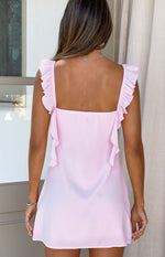 Rear view of a pink chiffon mini dress with a square back neckline and ruffled straps