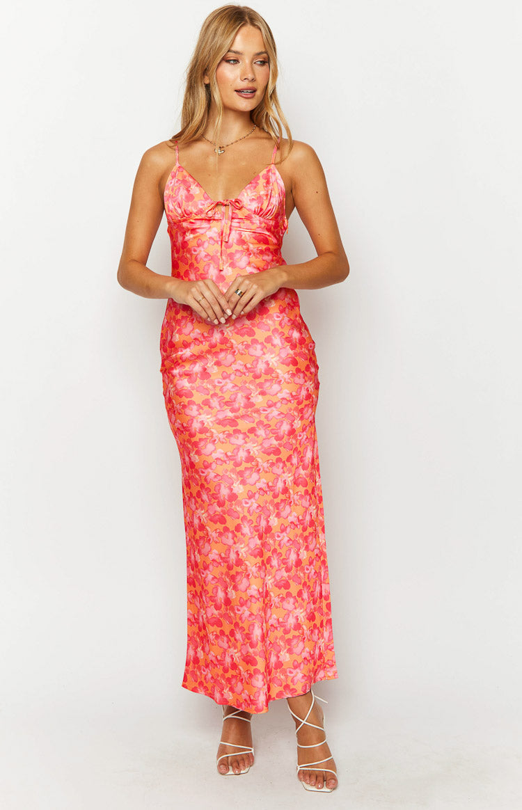 V-neck orange maxi dress with a pink floral print, delicate spaghetti straps, and a tie-front bust