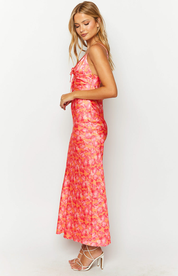 Side view of an orange floral print maxi dress with a tie-front bust and spaghetti straps
