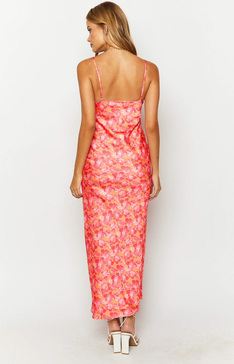 Back view of the orange floral print maxi dress with a straight back neckline and thin adjustable spaghetti straps