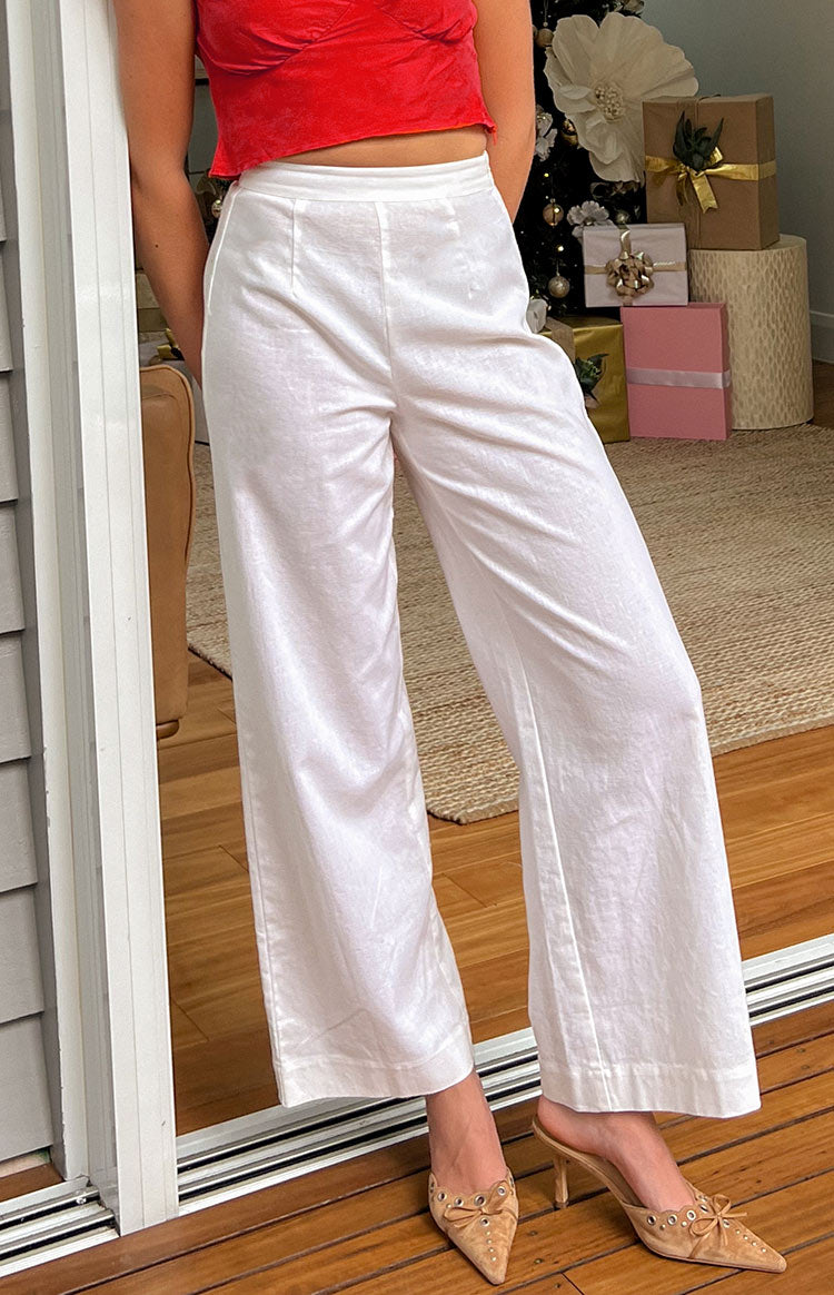 White linen wide-leg pants featuring a high waist, flat front, and subtle vertical leg seams