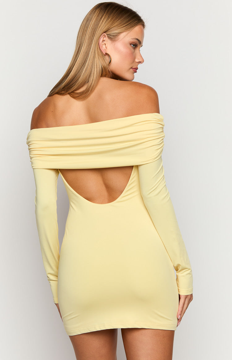 Rear view of a yellow off-shoulder long sleeve mini dress with a low scoop back cutout