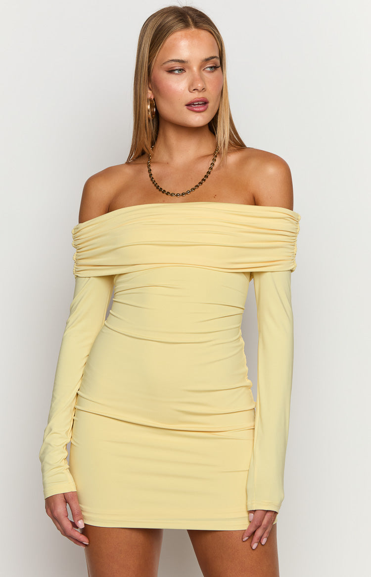 Front view of a yellow off-the-shoulder mini dress with a ruched neckline and fitted long sleeves