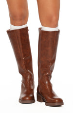 Front view of cognac brown mid-length boots with side zippers, rounded toes, and block heels