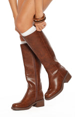 Side view of cognac mid length boots with a full-length side zipper and a stacked block heel