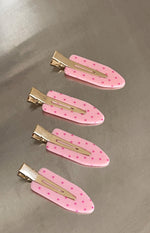 Four pink polka dot non-crease hair clips with gold metal clasps