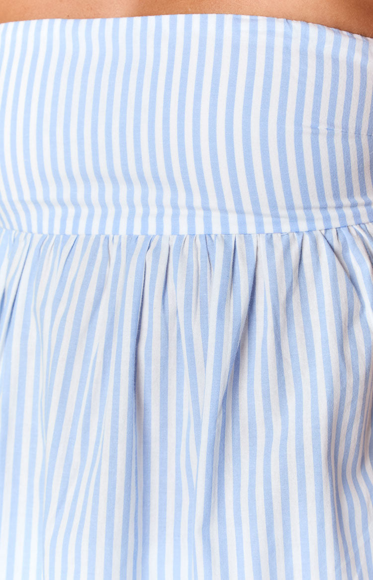 Close-up of the gathered waist detail on a light blue and white striped strapless top