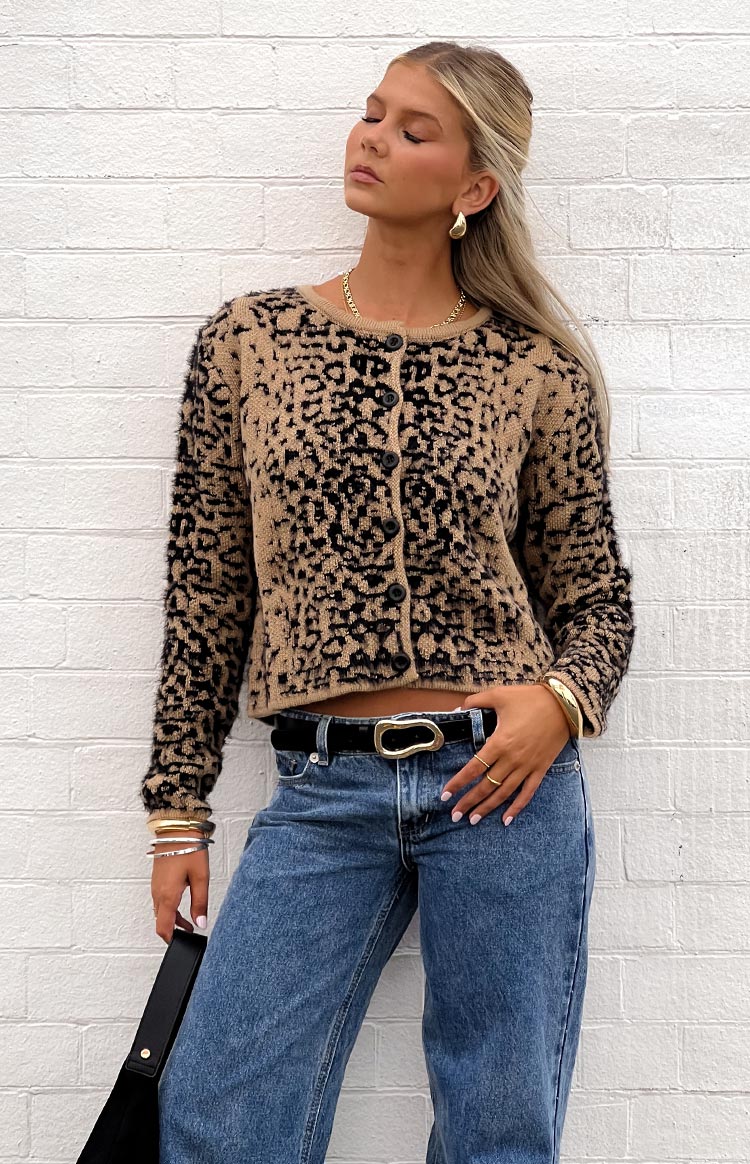 Tan and black leopard print fuzzy knit cropped cardigan with a round neck and button front