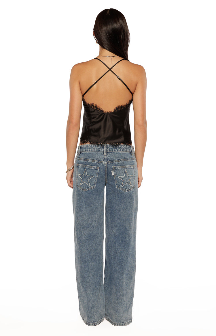 Rear view showing the criss-cross spaghetti straps and low scoop back of a black satin cami top