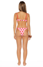 Rear view of pink and red polka dot bikini bottoms with high-cut leg and cheeky coverage