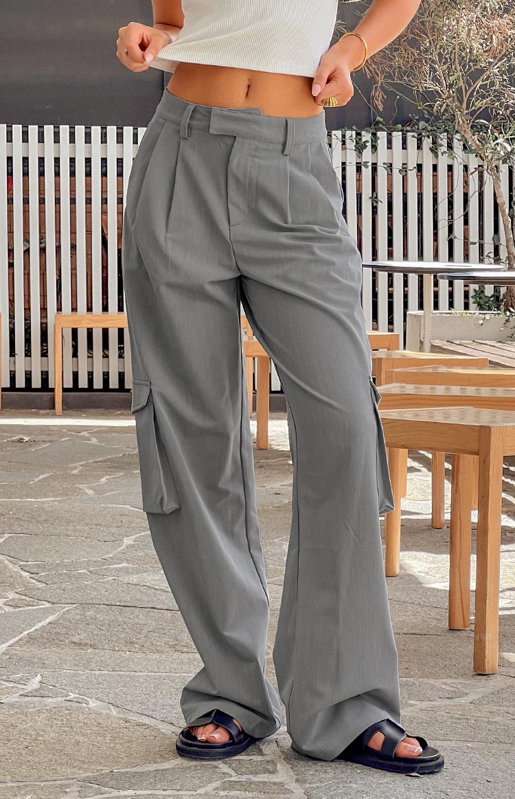 Full length view of grey straight leg pants with pleated front and cargo pockets on the side