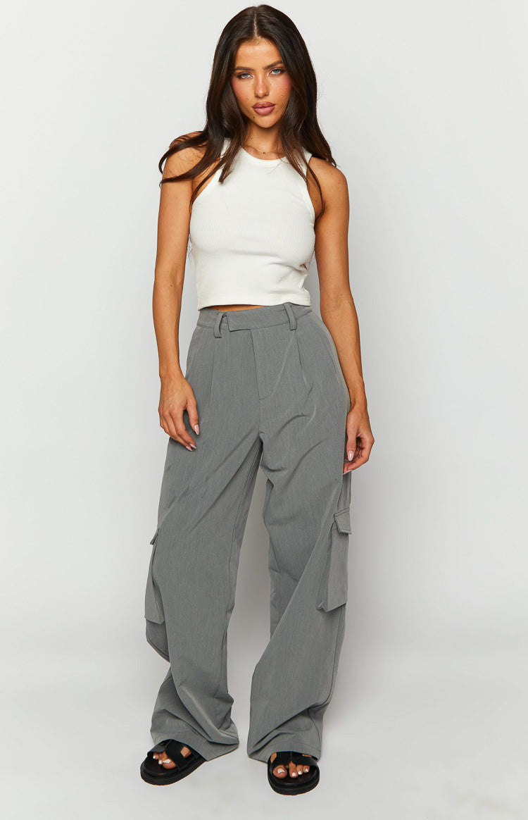 Grey straight leg pants with large cargo pockets on the sides and a pleated waist