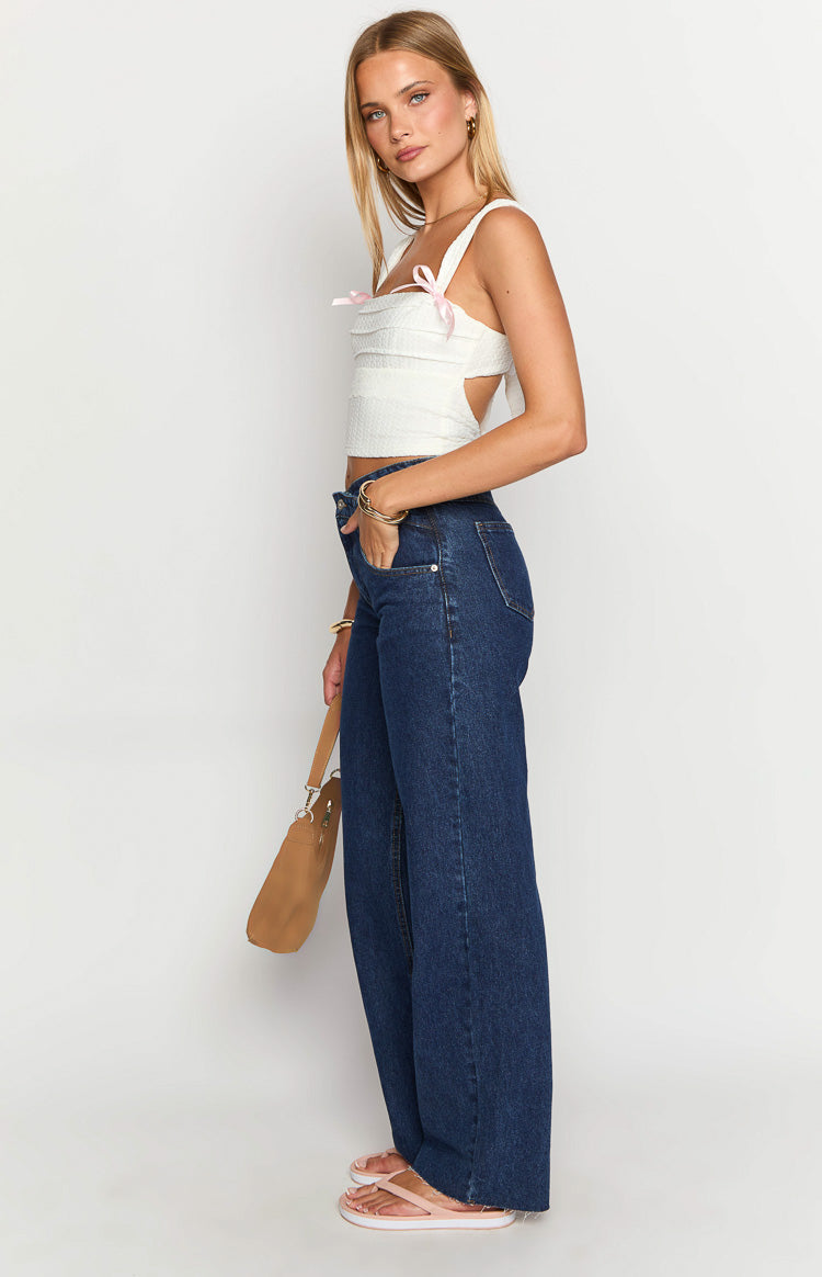 Side view of dark blue wide-leg jeans with a relaxed fit and full-length hem