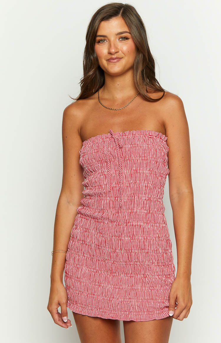 Close-up of the red and white gingham strapless mini dress with a shirred bodice and front tie detail