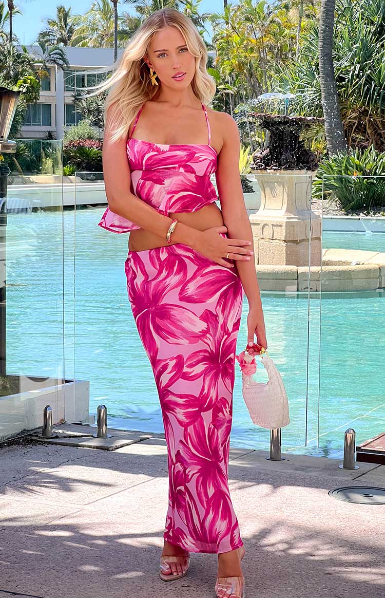 Full length view of a pink floral bodycon maxi skirt with a vibrant abstract pattern