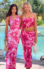 Full length view of a light pink maxi skirt with a vibrant dark pink floral pattern and a fitted silhouette