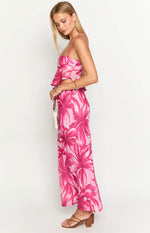 Side view of a light pink maxi skirt with large dark pink floral print, fitted at the waist and flowing silhouette
